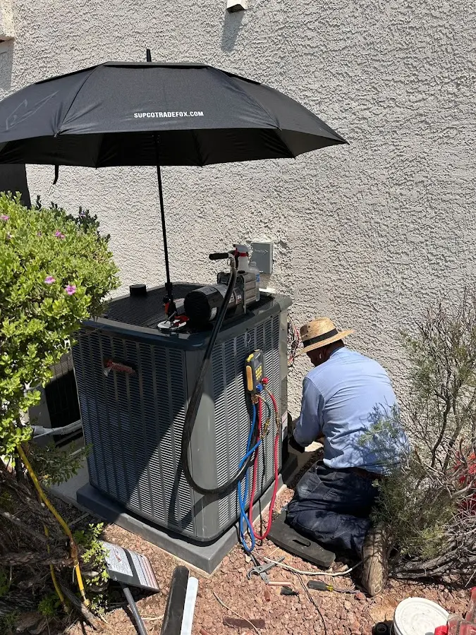 HVAC technician performing outdoor AC maintenance in Westminster