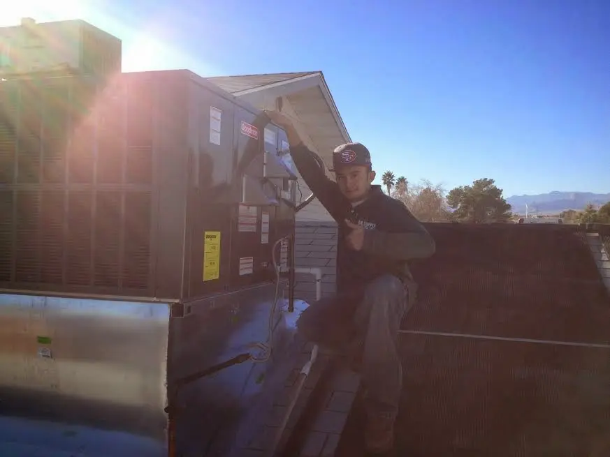 HVAC technician performing Boiler Repair on a rooftop unit in Westminster